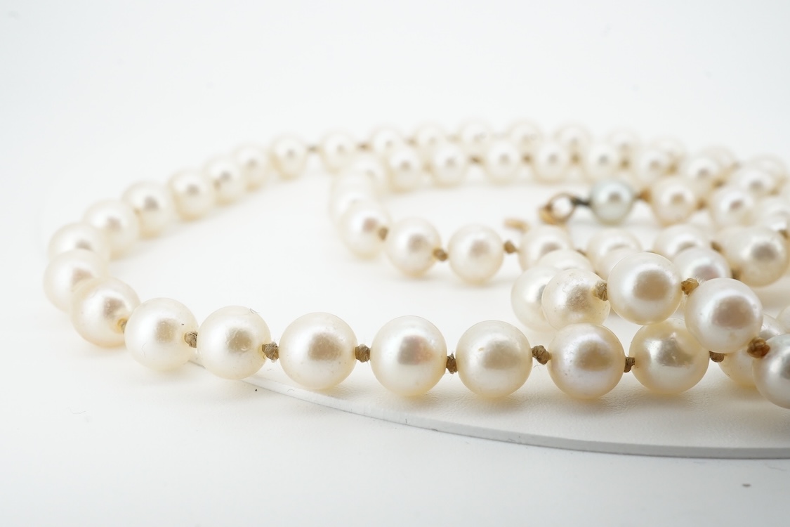 A cultured pearl and aquamarine necklace, composed of a single strand of cultured pearls, to a gold clasp set with an oval aquamarine, length 53.5cm, Condition: in good condition, minor wear, minor variations in pearl co